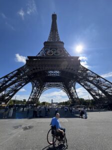 Bald man in a wheelchair at the Eiffel Tower